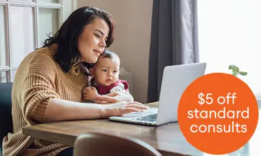Woman on laptop with child in lap