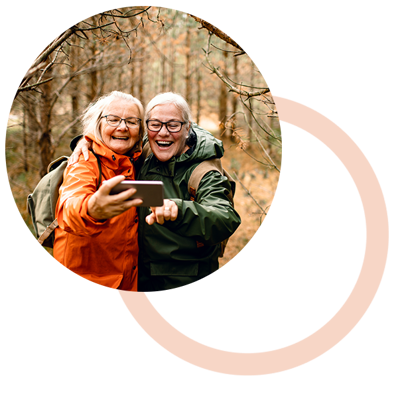 Two women bushwalking looking at phone